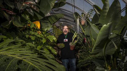 Jeff Witkowski, greenhouse manager for Agricultural Research Division, holds a couple of his favorite specimens in the East Campus “jungle.” The greenhouse, which is filled with tropical plants, a banana tree and succulents, is used as a teaching classroom. The facility, which is among greenhouses maintained by a team led by Witkowski, has been featured in remote teaching lessons through the end of the spring semester.