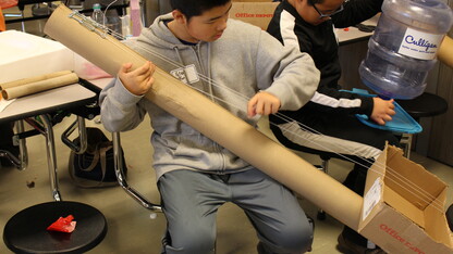 Under the direction of Kennedy Center teaching artist and science educator John Bertles, Science of Sound Spring Break Camp participants experiment with sound on musical instruments created from recycled materials at Dawes Middle School in 2014.