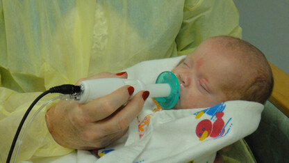An infant uses the NTrainer System, a therapy device developed by UNL's Steven Barlow to stimulate early development of essential feeding skills in preterm infants.