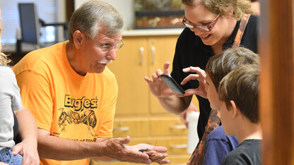 Entomology Professor Fred Baxendale introduces Vinnie the vinegaroon to a BugFest guest in 2015.