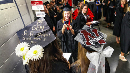 First-generation Husker Maritza Alvarez and fifth-generation Husker Lauren Hubka pose for a photo before the start of August commencement at Pinnacle Bank Arena.