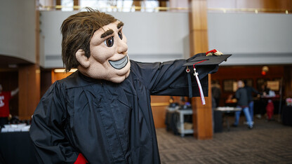 Herbie Husker gets fitted with a commencement gown during Nebraska Gradfest in late November at the Wick Alumni Center. The university's December commencement exercises are Dec. 14 and 15 at Pinnacle Bank Arena.