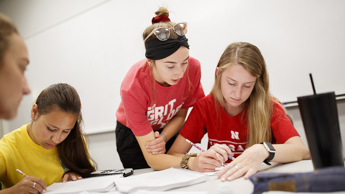 Taylor Hickey, a freshman from Elwood, works with Kaelyn Tejral, a freshman from Lincoln, during a CALC106 recitation taught by Justin Nguyen in Pound Hall 105. At left is Leavitt Reno, a freshman from Grand Island.