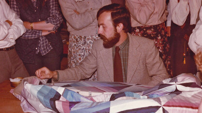 Michael James demonstrates his hand-quilting method for workshop participants at Strawberry Fayre, a quilt shop in Stockbridge, England, in 1980. The shop’s owners, Jenny and Alec Hutchison, were responsible for bringing James to England for the first time in 1980. Through the ’80s and ’90s, he lectured and taught workshops there and throughout Europe annually, networking widely with fellow quilt artists.