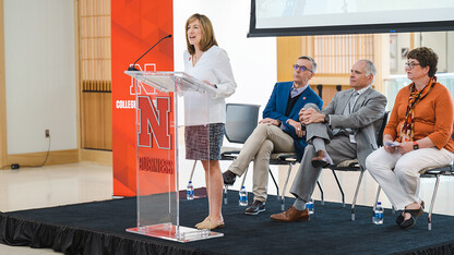 Kathy Farrell, dean of the College of Business, speaks during the announcement of the new Nebraska Business focus program at Lincoln’s Standing Bear High School on May 10. Seated behind her are (from left) Chancellor Ronnie Green, Lincoln Public Schools Superintendent Steve Joel and Standing Bear Principal Sue Cassata.