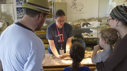 A family learns more about fossils from one of Ashfall Fossil Beds’ summer interns at the park’s Working Visible Lab.