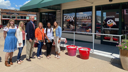 Rural Fellows Alicia Pannell (left), Tori Pedersen (second from left) and Janet Kabetesi (fifth from left) and community fellows Andrea McClintic (fourth from left) and Stephanie Novoa (right) are pictured with Lt. Gov. Mike Foley (third from left) at the Fox Theater ribbon cutting in Cozad.