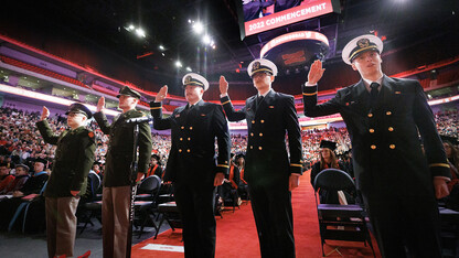 Five Army and Naval ROTC graduates repeat the oath of office during the undergraduate commencement ceremony Dec. 17 at Pinnacle Bank Arena. They are (from left) 2nd Lts. Jack O’Dell and Aubrey Fangmeier, Army; and Ensigns Cohan Bonow, John Carpenter and Nathan Hills, Navy.