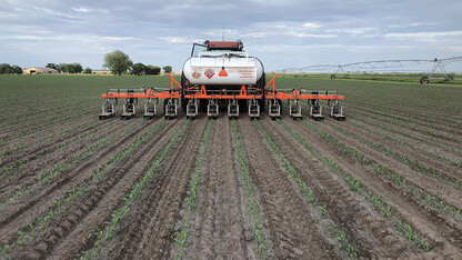 Flame weeder equipment is used on a field during a Systems Approach to Weed Control workshop.