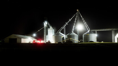 A farm site with four silos at night