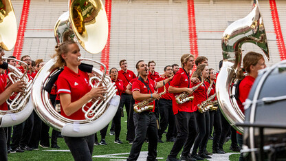 Some Cornhusker Marching Band members sing, while others play instruments during the band's annual exhibition Aug. 18 at Memorial Stadium.