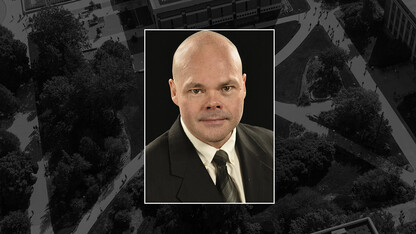 A color photo of Jonathan P. O'Brien on a black campus background