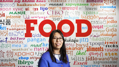 Bing Wang, in front of a wall with words in numerous languages