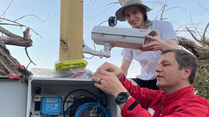 Troy Gilmore and Chris Terry work on a U.S. Geological Service camera.