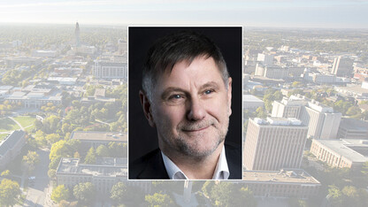 Color portrait of Steve Evans on a color campus background