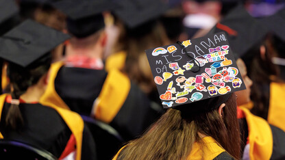 Amanda Ottersberg of Lincoln wears a mortar board decorated by her preschool students during the graduate and professional degree ceremony Dec. 20 at Pinnacle Bank Arena.