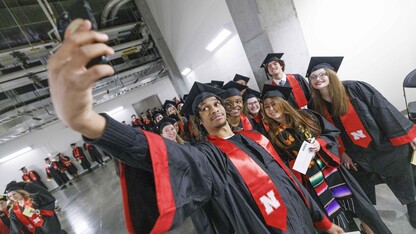 Cameron King of Omaha takes a selfie with his fellow College of Journalism and Mass Communications graduates before the undergraduate commencement ceremony Dec. 21 at Pinnacle Bank Arena.