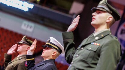 Three male members of the University of Nebraska–Lincoln's Reserve Officer Training Corps, in uniform, recite the oath of enlistment during the undergraduate commencement ceremony Dec. 21 at Pinnacle Bank Arena.