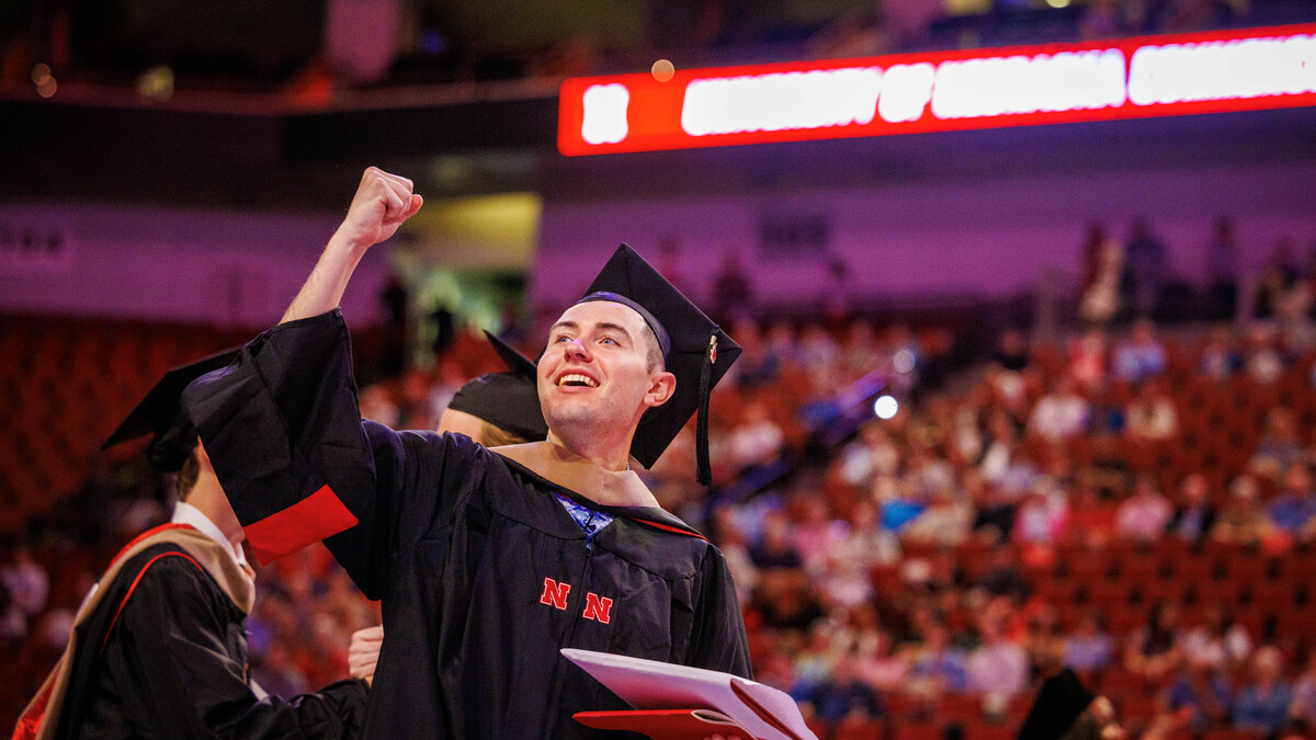 Connor Morrissey pumps his right first in the air as he leaves the graduate and professional degree ceremony May 16 at Pinnacle Bank Arena. He earned a Master of Professional Accountancy.