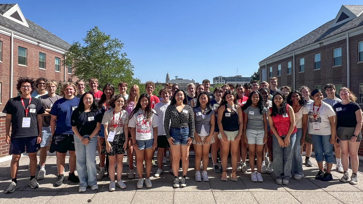 About 38 college students — all members of the Jeffrey S. Raikes School of Computer Science and Management — pose for a photograph on the rooftop of the Kauffman Academic Residential Center on a clear day.