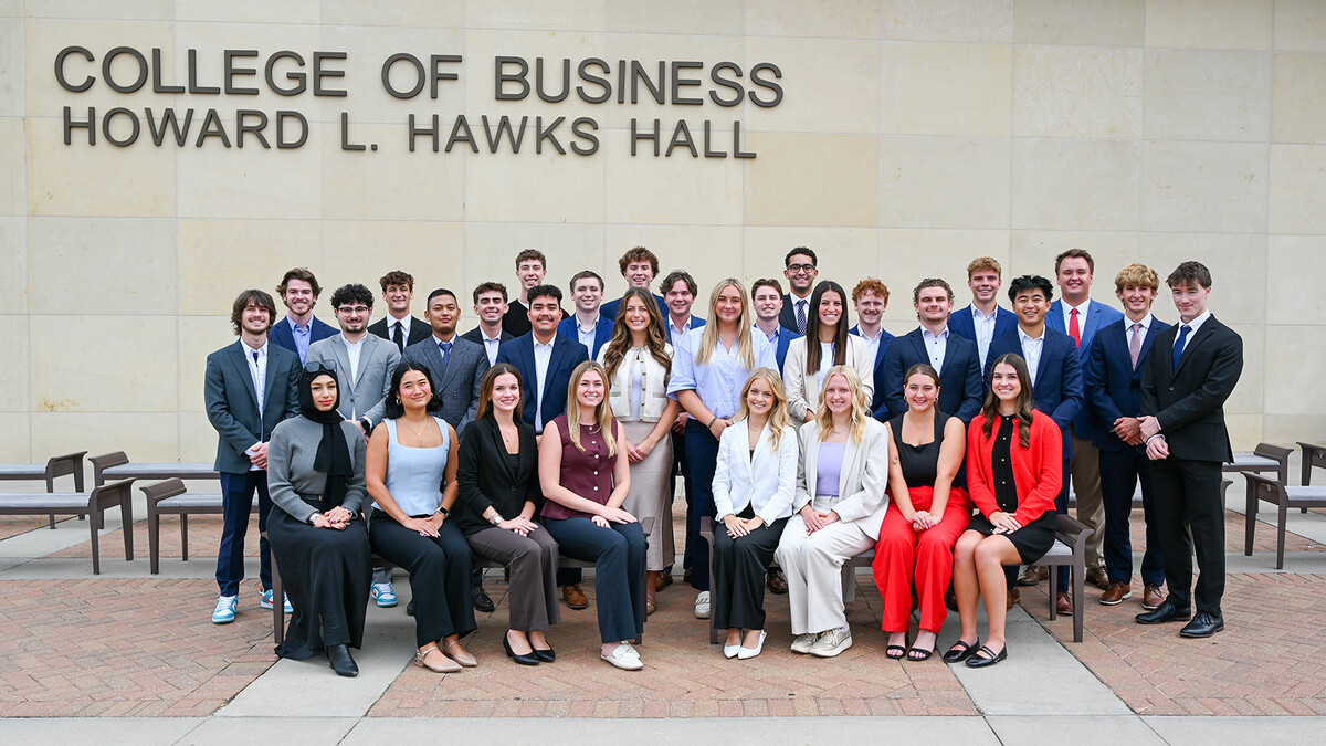 Thirty-one students — all members of the 10th cohort of the Clifton Builders Program at the University of Nebraska–Lincon — pose for a photograph in formal attire on the west side of Howard L. Hawks Hall.