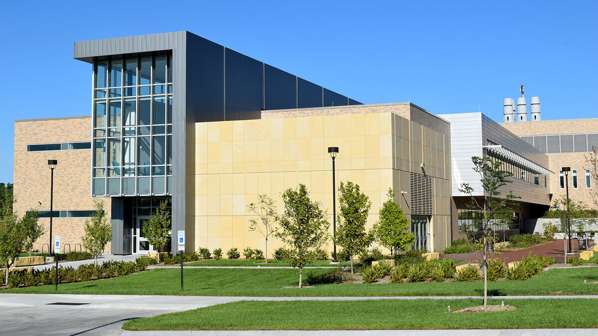 Exterior photo of the School of Veterinary Medicine and Biomedical Sciences building on a clear day.