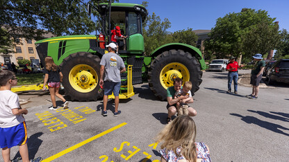 Children examine a John Deere tractor during East Campus Discovery Days on June 12.