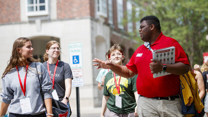 Orientation leader Jayven Brandt shares his experiences as a Husker with incoming freshmen outside the Nebraska Union.