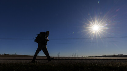 Trevor Stephens, Marine Corp veteran and a sophomore in secondary education from Council Bluffs, Iowa, walks along Highway 93 westbound from Treynor, Iowa.