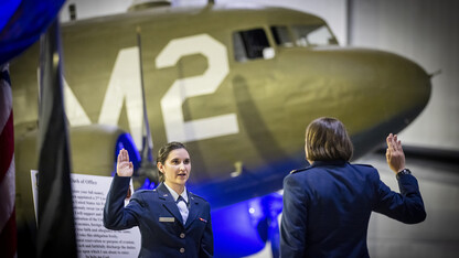 Lt. Isabel Welch recites the Oath of Office as directed by Air Force Major Nicole Beebe on May 16. The university’s Air Force ROTC detachment held a commissioning for May graduates at the Strategic Air Command and Aerospace Museum in Ashland. Welch will begin her service as a logistics readiness officer at Offutt Air Force Base in Omaha. In the background is a C-47 from World War II.