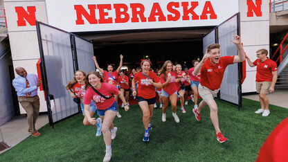 Members of the Class of 2027 lead the group onto the field during the Tunnel Walk in Memorial Stadium.