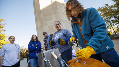 Dylan Kapustka, sophomore in history, makes a pour into the mold of a pilgrims’ badge of Thomas Becket, former Lord High Chancellor of Great Britain, as Carolyn Twomey watches.