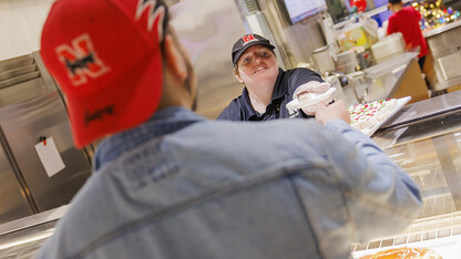 Gretchen Hamilton serves up a student’s choice of petit fours at the Cather Dining Complex.