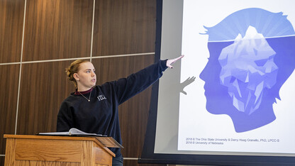 Madi Pfeiffer, a Big Red Resilience and Well-Being ambassador, goes over statistics about suicide for a REACH training session.