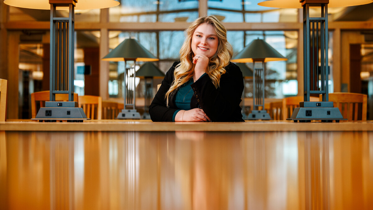 Delaney Doyle poses for a photo in the Marvin & Virginia Schmid Law Library