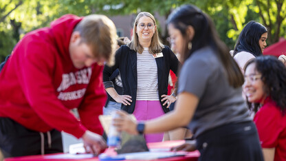 Jenni Brost smiles as she watches an incoming student interact with a New Student Enrollment leader.