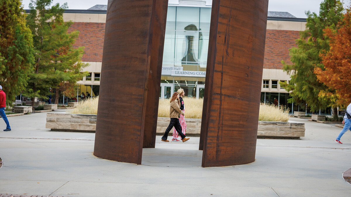 Fans walk through campus, in front of the Adele Hall Learning Commons.