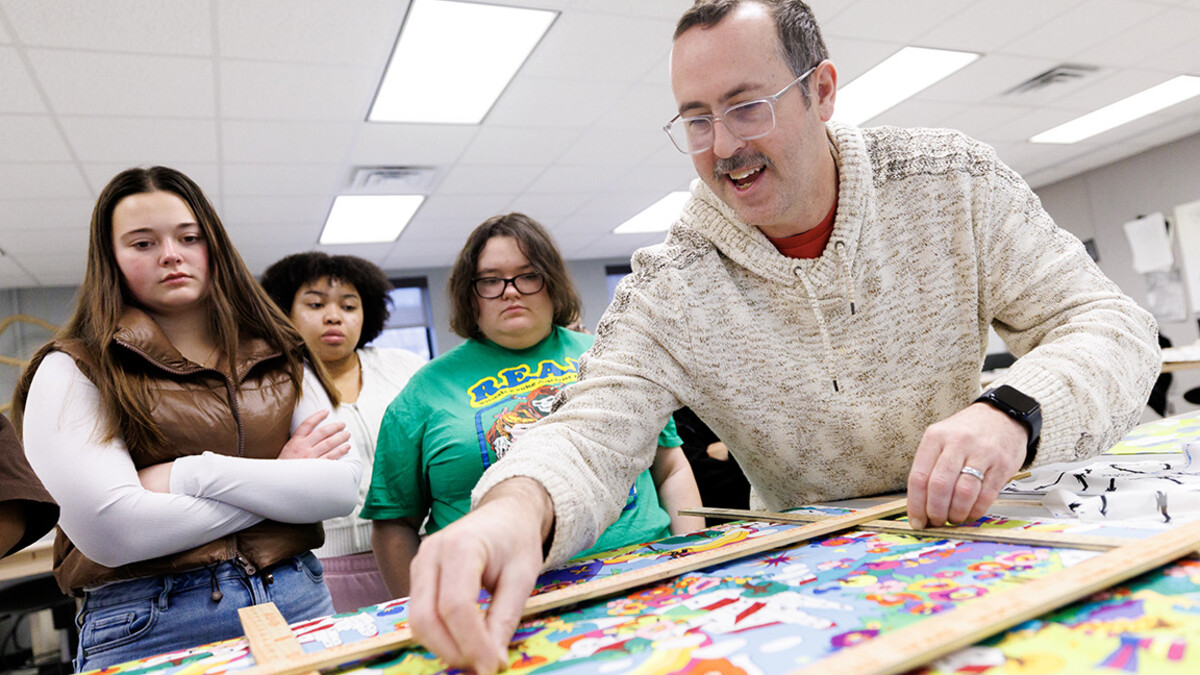 Michael Burton, assistant professor in the Department of Textiles, Merchandising & Fashion Design, identifies a pattern in a textile during his Advanced Design for Printed Textiles class inside the Gwendolyn A. Newkirk Human Sciences Building.