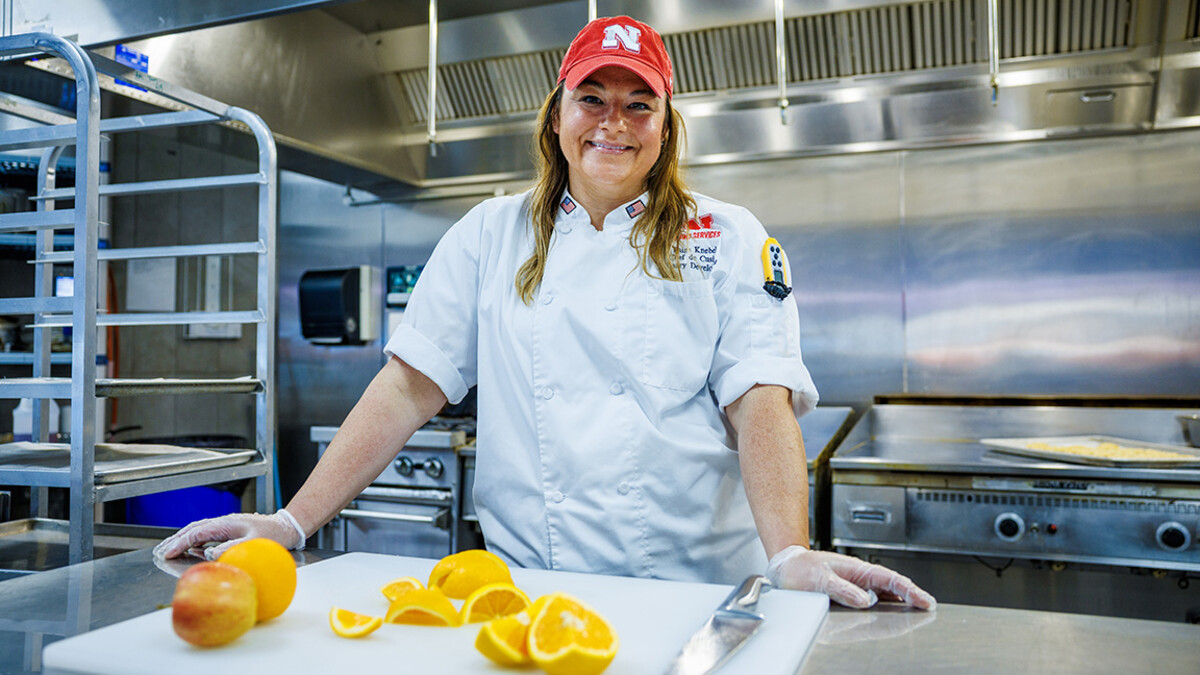 Paige Knebel stands in an industrial kitchen