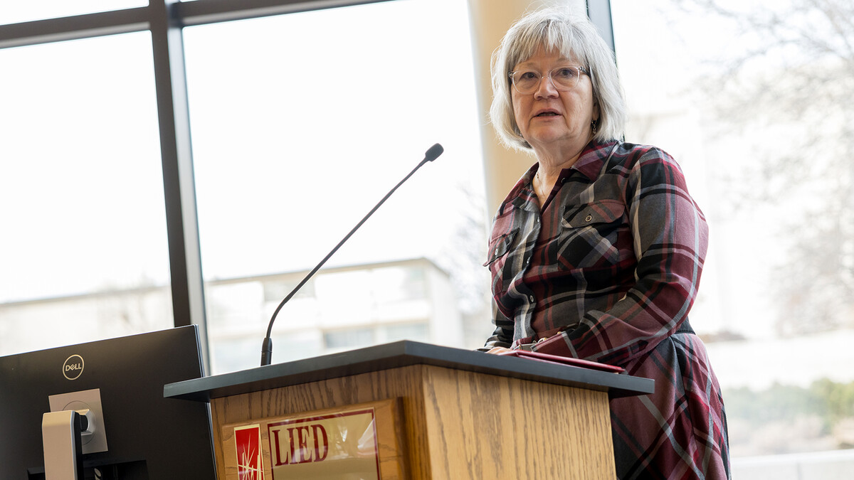 Leslie Reed, public affairs director with University Communication and Marketing, delivers a speech during her retirement party in the Lied Center Commons on Dec. 9.