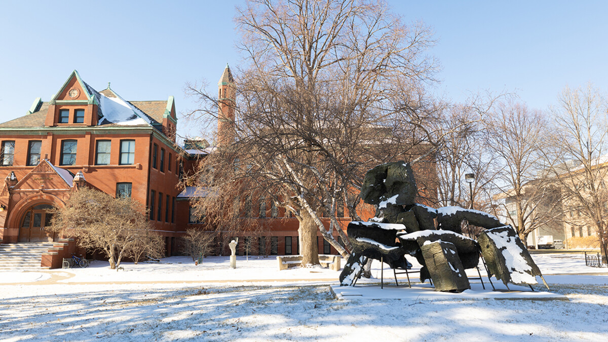 Snow coats the lawn and sculptures in front of Architecture Hall.