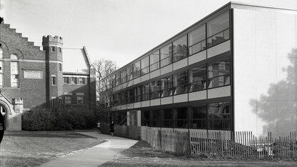 Image from November 1963 showing Woods Hall surrounded by construction fence in the foreground and Grant Memorial Hall in the background.