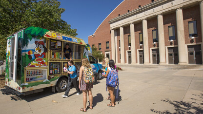 Students wait to order shaved ice from the Kona Ice truck outside the Coliseum on Sept. 20. The food truck is the first to take part in a new program offered by the Nebraska Unions.