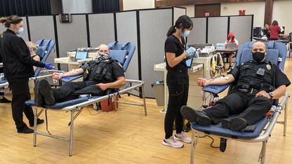 Two university police officers give blood during the university's homecoming week blood drive in the Nebraska Union.