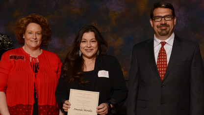 Amanda Morales (center) receives her first Parents' Recognition Award from (right) Scott Napolitano, teaching council chair and assistant professor of practice in educational psychology, and Linette Asay, UNL Parents Association president.