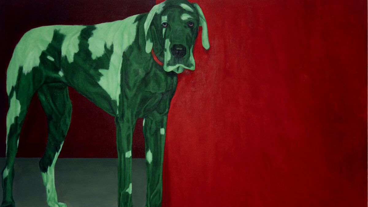 A painted green dog looks forlorn. The dog is painted on a red background.