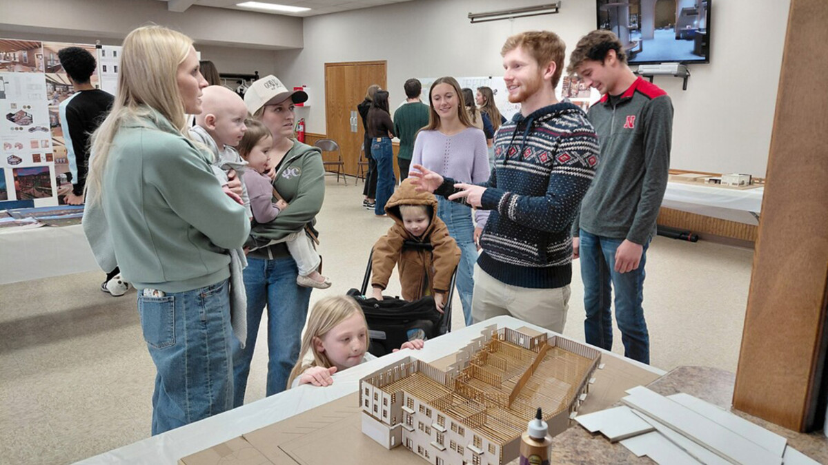Students meet with Axtell residents in a conference room.