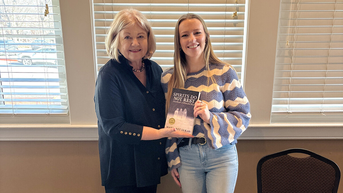 Margaret Lukas and Ellie Maxwell are photographed with the book cover.