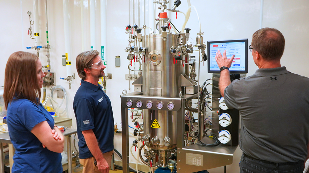 NSRI Senior Scientists Aimee Ketner, left, and Zachary Minter, middle, get an overview of the new Eppendorf BioFlo® 610 fermentation system from BPDF GMP Coordinator Scott Johnson.