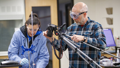 Jessica Periago (left) and Kurt Wulser (right) film an experiment for chemistry students. The videos are replacing hands-on labs the students were scheduled to complete during the spring semester.